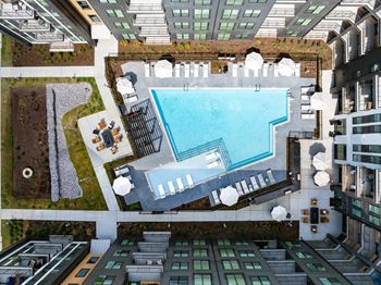 an aerial view of a swimming pool in the middle of an apartment building